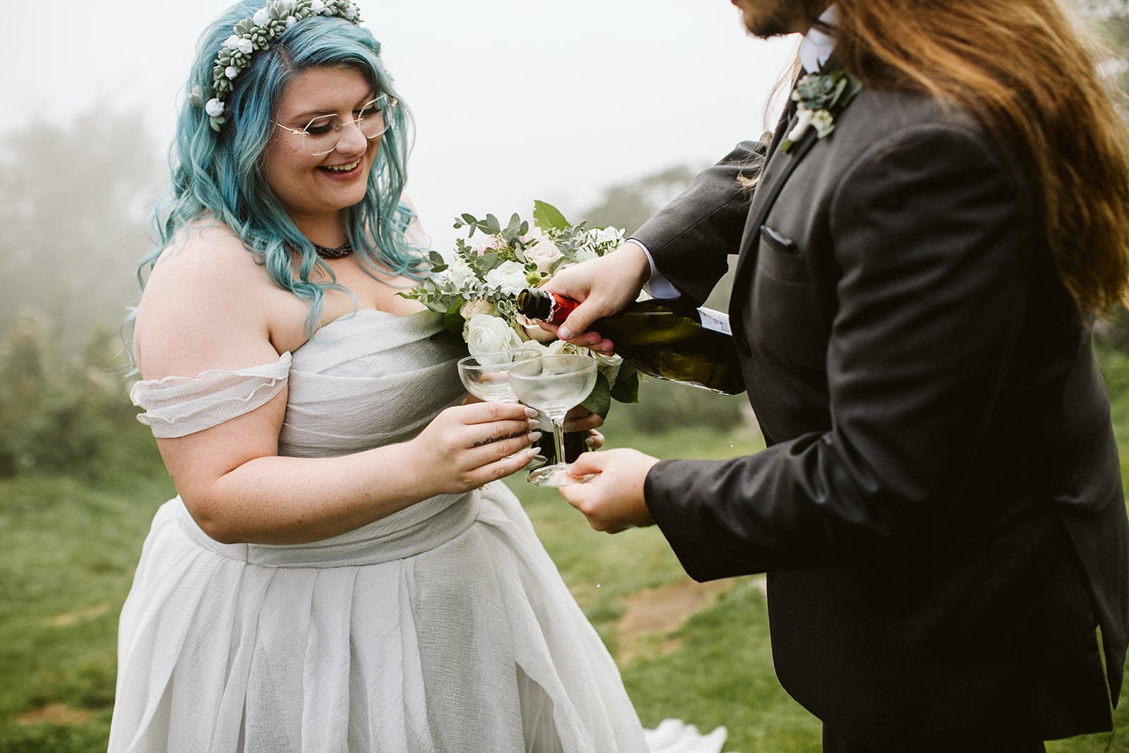 Anthony pours Amanda Champagne on a mountaintop during their Asheville Elopement
