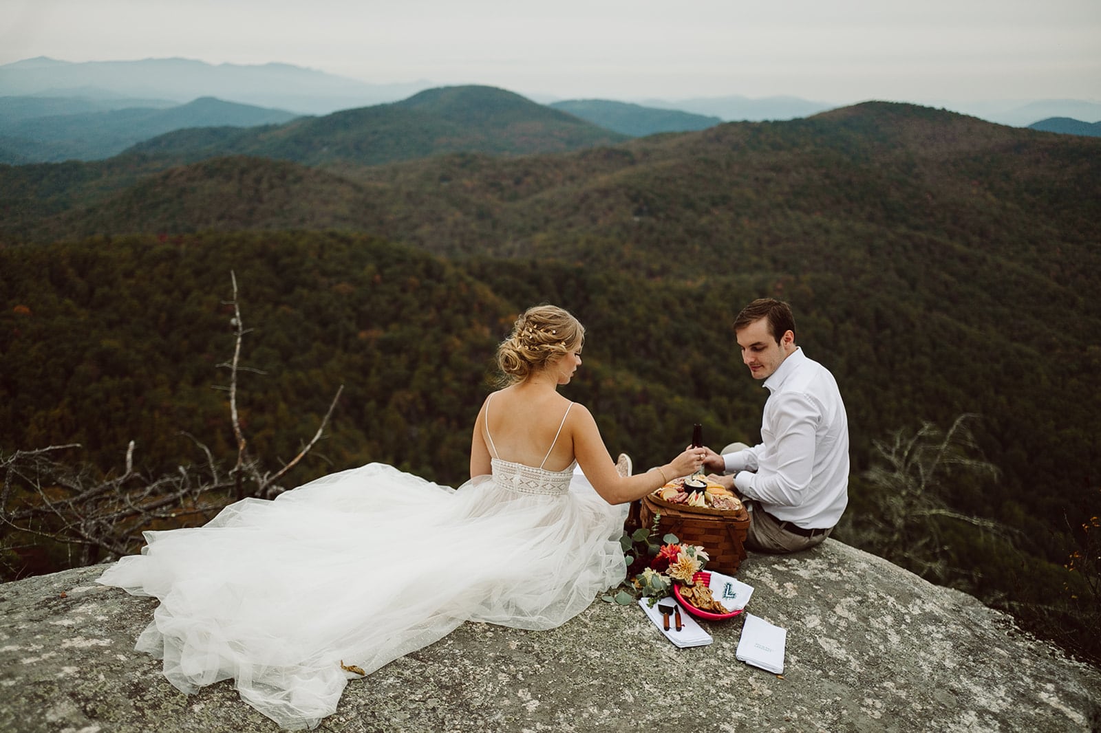 Becca and Andrew enjoy a picnic with a mountain view on their Asheville Adventure Elopement