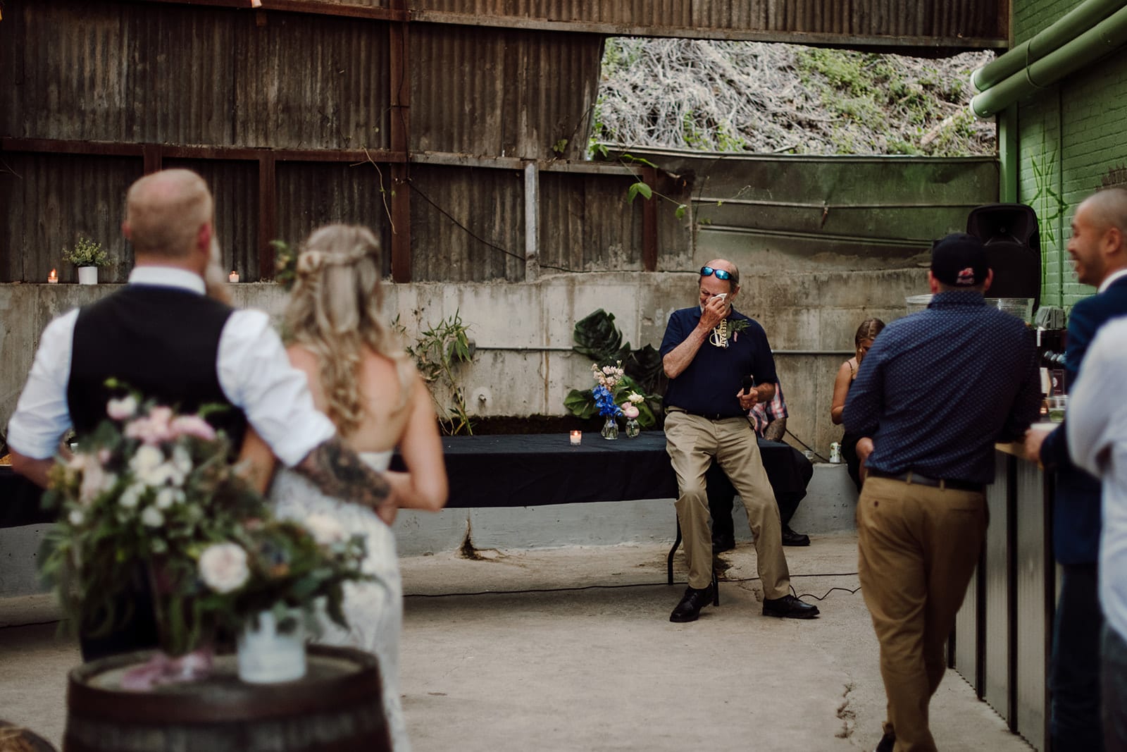 A wedding guest shares an emotional toast to Corey and Drew at their wedding celebration at Highwire Brewing in Asheville, NC