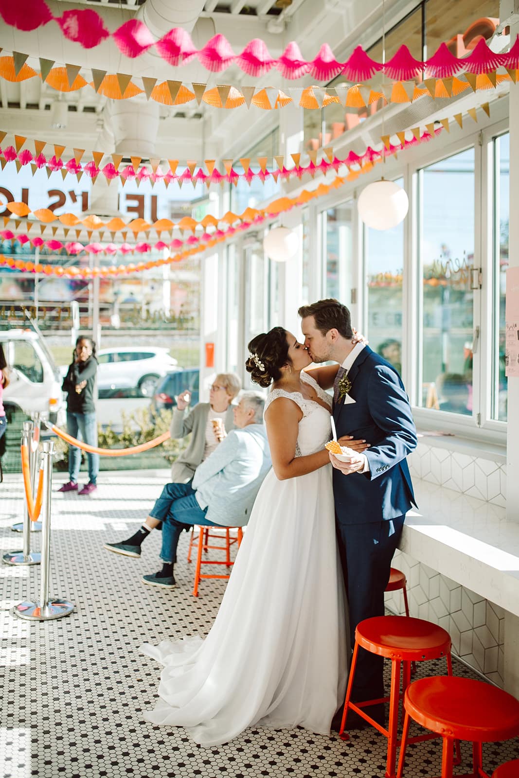 Jessa and Kory share a kiss in a diner for one of the Asheville Elopement Photographs