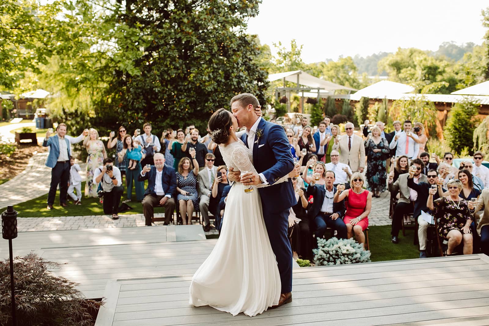 Jess and Stefan share their first kiss in front of friends and family during their Asheville Wedding celebration at Haiku I Do