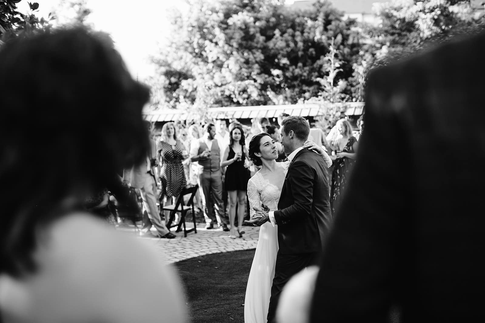 Jessica + Stefan are lost in their first dance, while their friends and family surround them at Haiku I Do for their Asheville Wedding