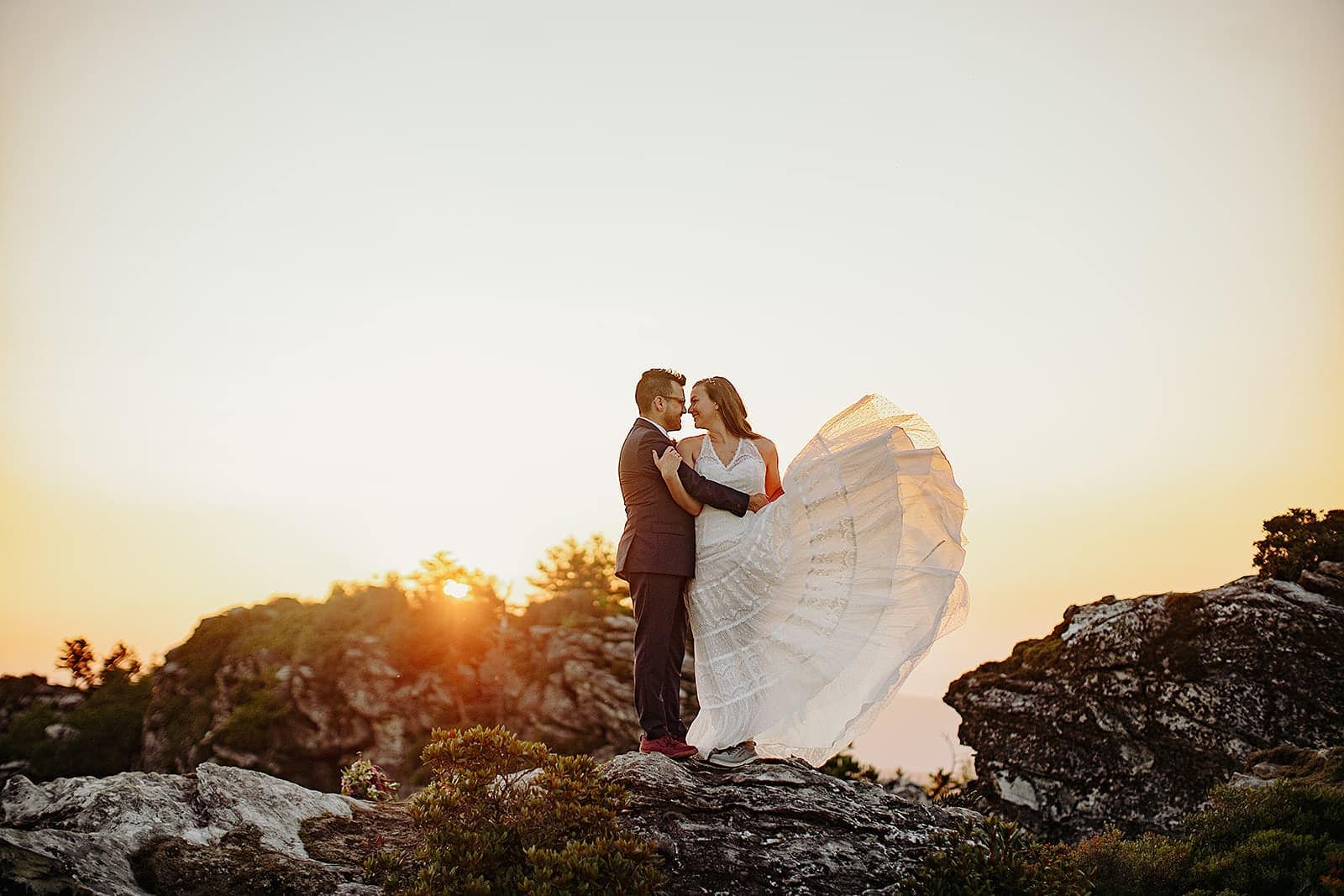 The bride's dress flares out into the morning sun during their Asheville Adventure Elopement