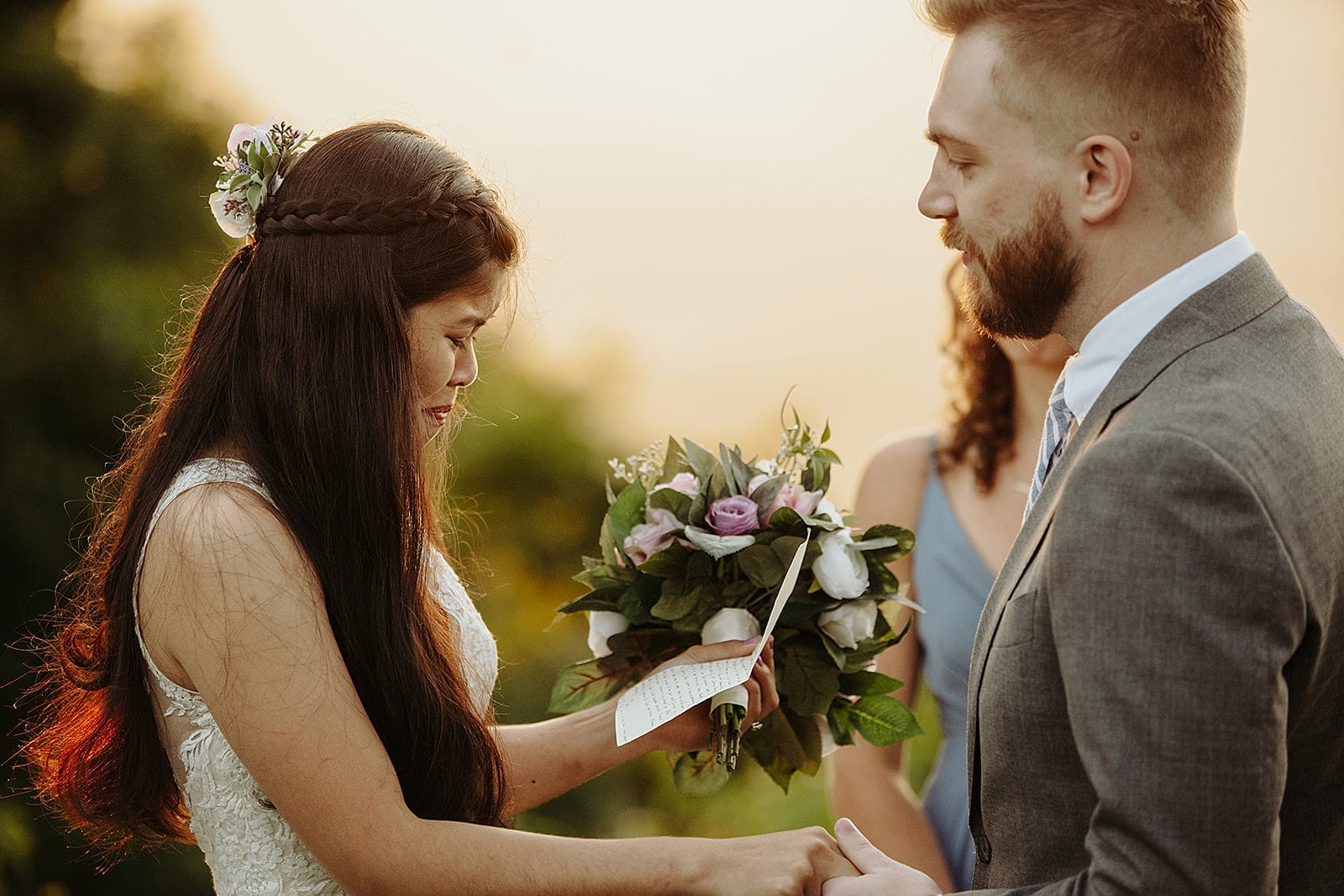 Sandy and Josh join hands during their mountaintop ceremony on their Asheville Adventure Elopement