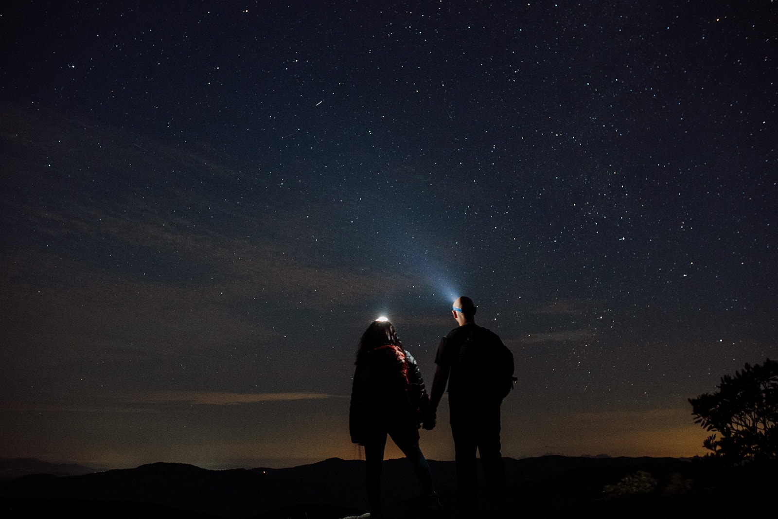 Mariel and Stephen join hands under the stars off the Blue Ridge Parkway during the Asheville Elopement