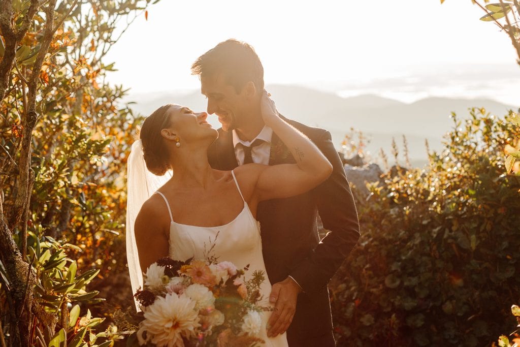 Bailey + Daniel embrace in the sunrise light during their adventure elopement in the Blue Ridge Mountains