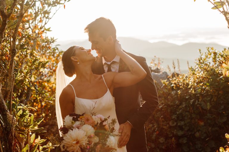 Bailey + Daniel embrace in the sunrise light during their adventure elopement in the Blue Ridge Mountains