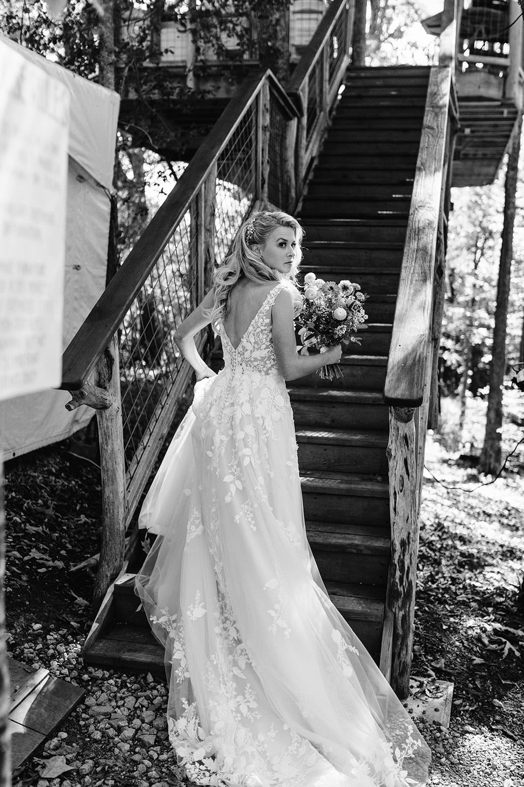 Diane climbs the treehouse at June Bug for her Asheville wedding
